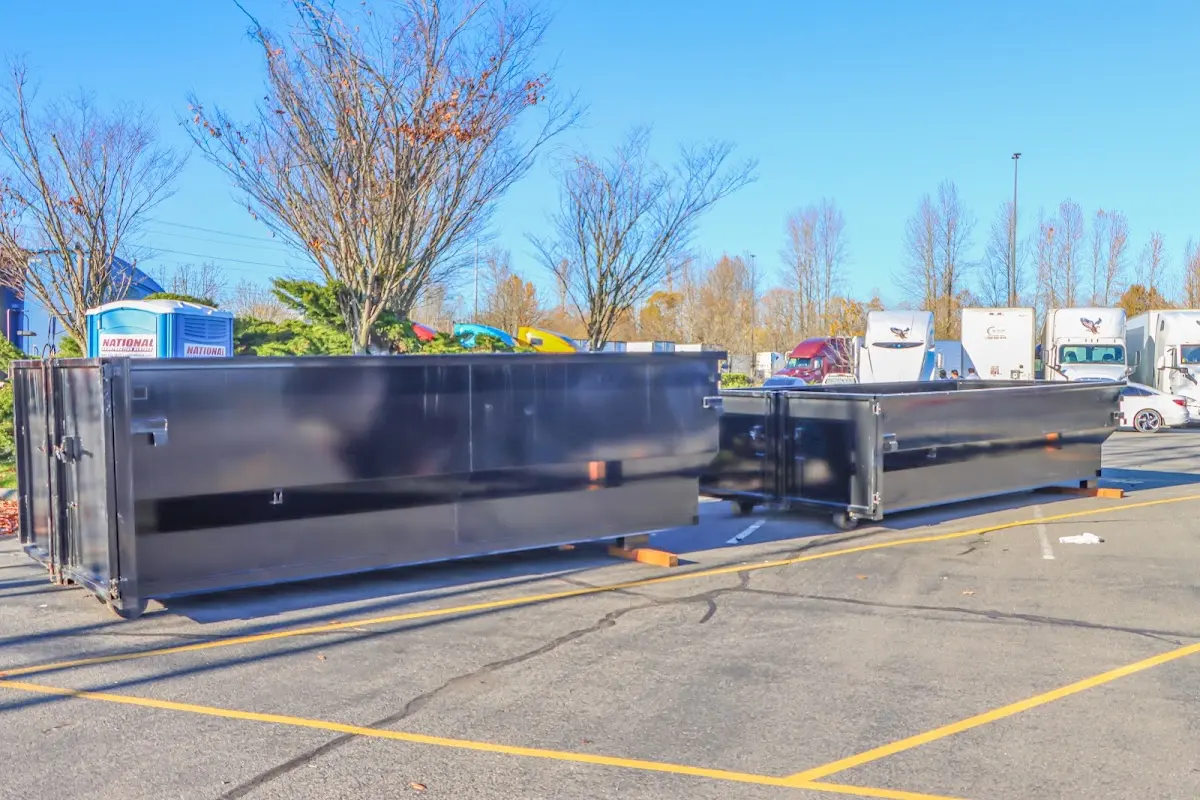 Professional dumpster rental service with roll-off container on residential driveway in Bolton